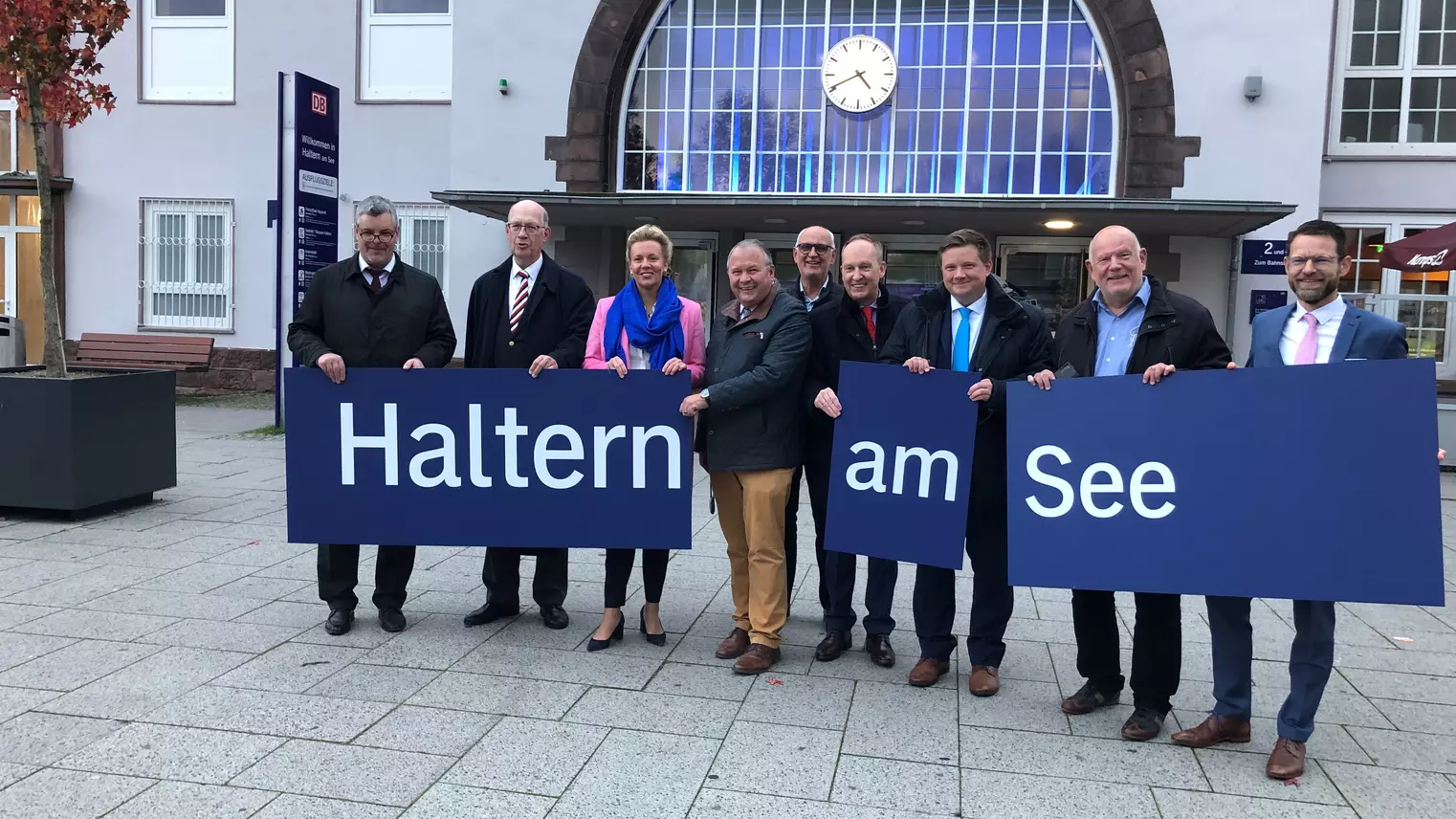 Die Beteiligten der Sanierung halten die Schilder "Haltern am See" hoch