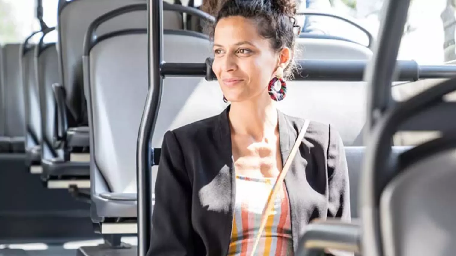 Young woman sits in bus